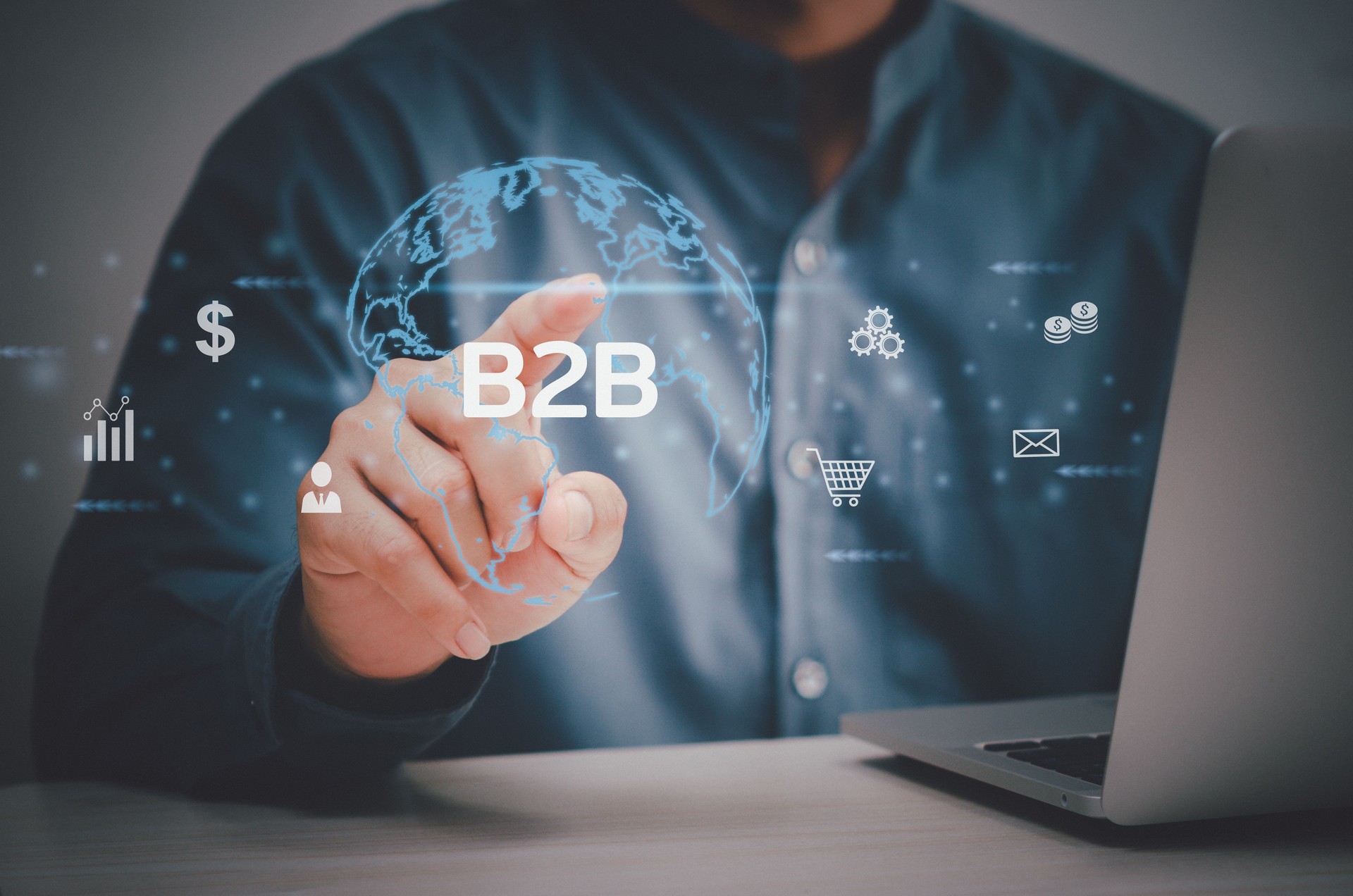 man hand using laptop virtual screen B2B Business to Business icons and symbols. Business digital technology marketing online concept.