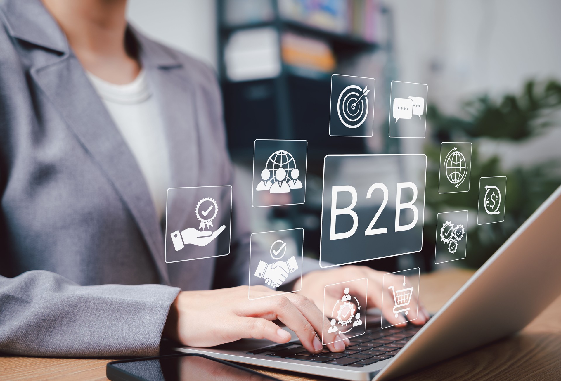 B2B Marketing and Business Collaboration Strategy Concept. Businesswoman using laptop with B2B marketing icons, symbolizing business to business communication, collaboration, trade, and strategy.